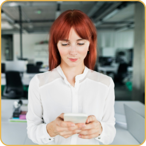 A female executive looking at content on her mobile phone.